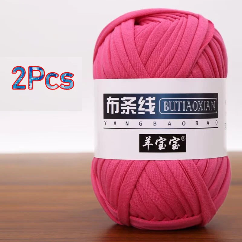 A skein of bright pink soft chunky t-shirt yarn for crochet and knitting, packaged as a 2-pack.