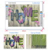 Diamond painting kit showing the word HOME in various shades of green and pink flowers on a wooden background