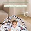 A baby is playing on a multi-functional fitness game stand mat with hanging toys and exercise elements.
