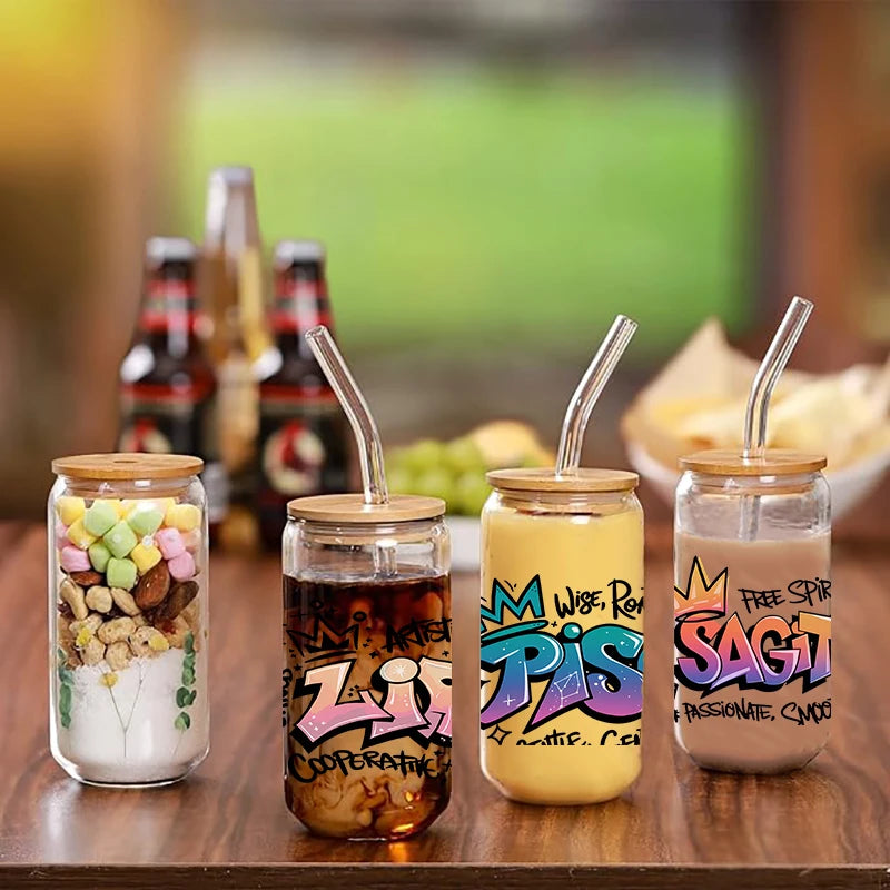 Five glass jars filled with colorful liquid and natural ingredients, featuring Zodiac sign graffiti art stickers.