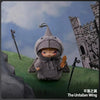 A gray plush doll wearing a hood stands in front of a stone castle backdrop.