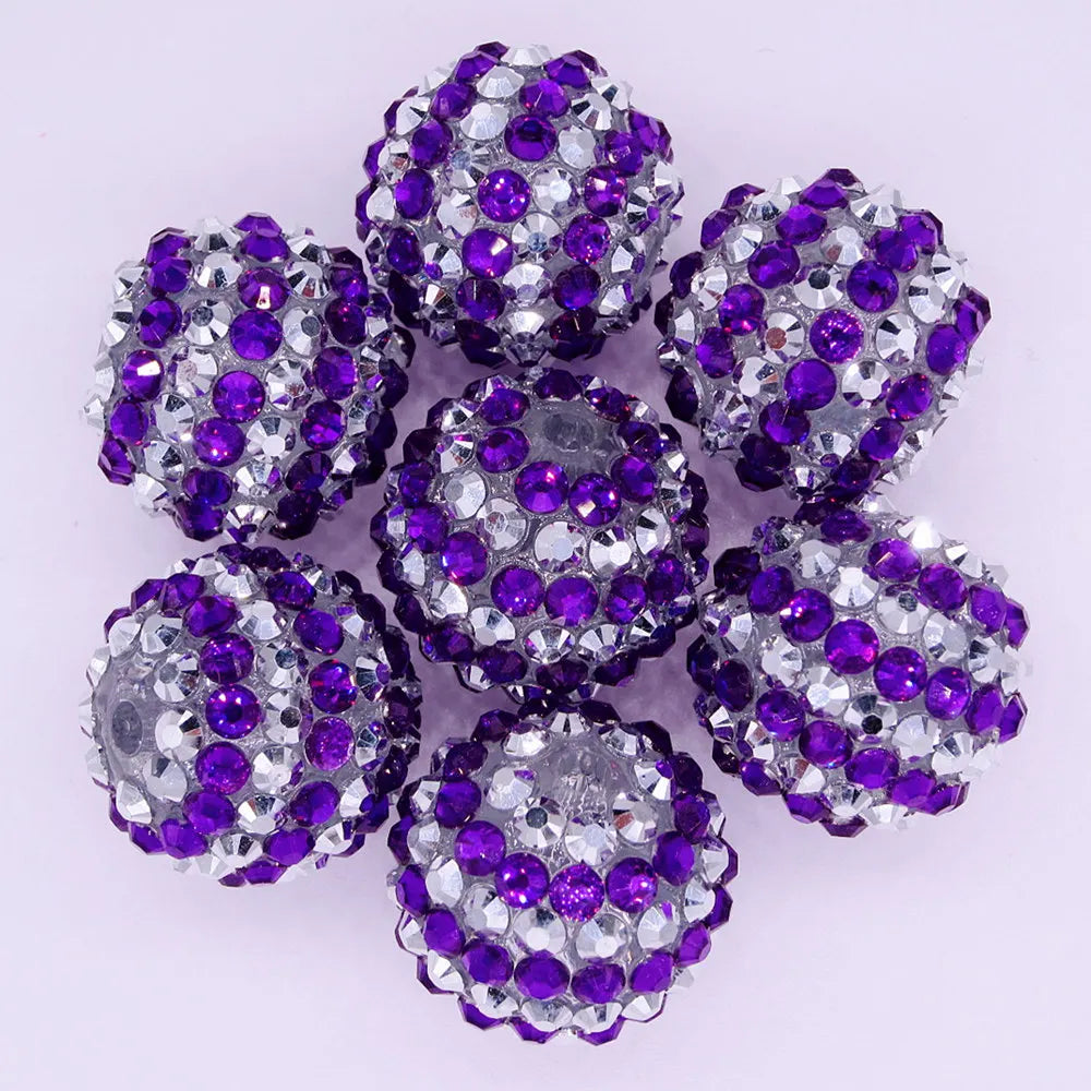 A cluster of purple and silver mixed two-tone striped resin beads for jewelry making
