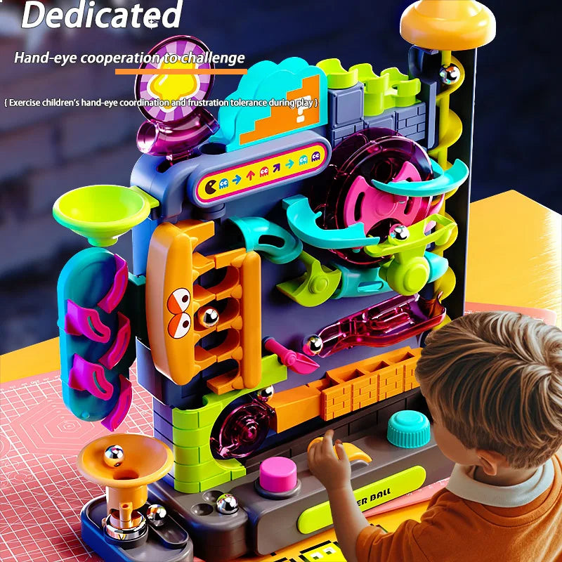 A child is playing with a multi-layered rolling ball track adventure toy featuring colorful plastic components.