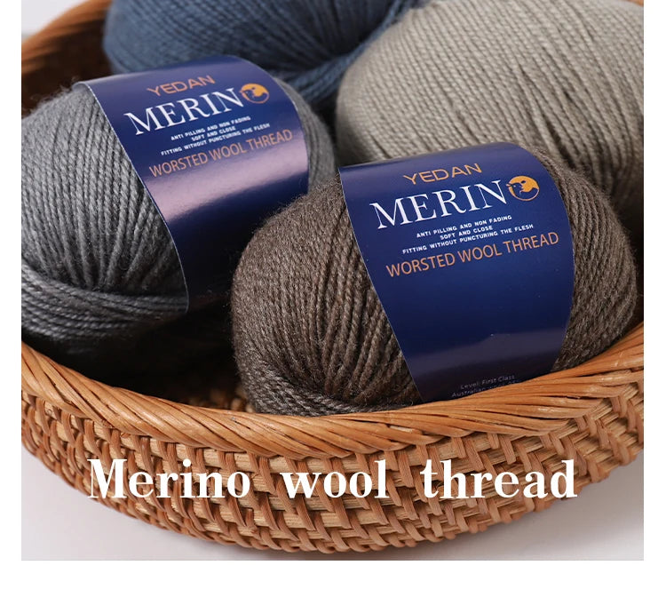 A bundle of YEDAN MERINO worsted wool thread yarn in gray and beige colors resting in a woven basket.