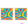 Two wooden puzzle blocks featuring colorful, swirling rainbow patterns for a Montessori activity.