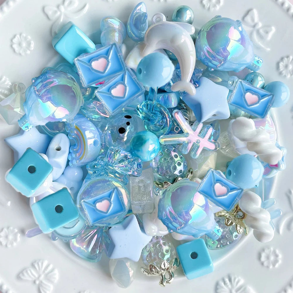 A collection of iridescent blue and white acrylic bow and flower beads for DIY jewelry making