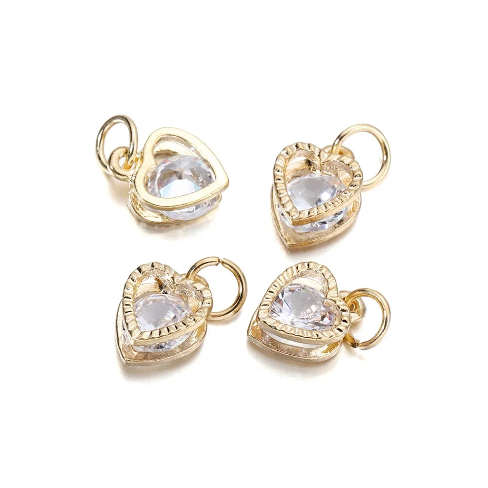 Two gold-toned heart charms with clear rhinestones, designed for jewelry making.