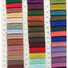 A collection of folded fabric napkins in various shades of green, pink, beige, and blue.