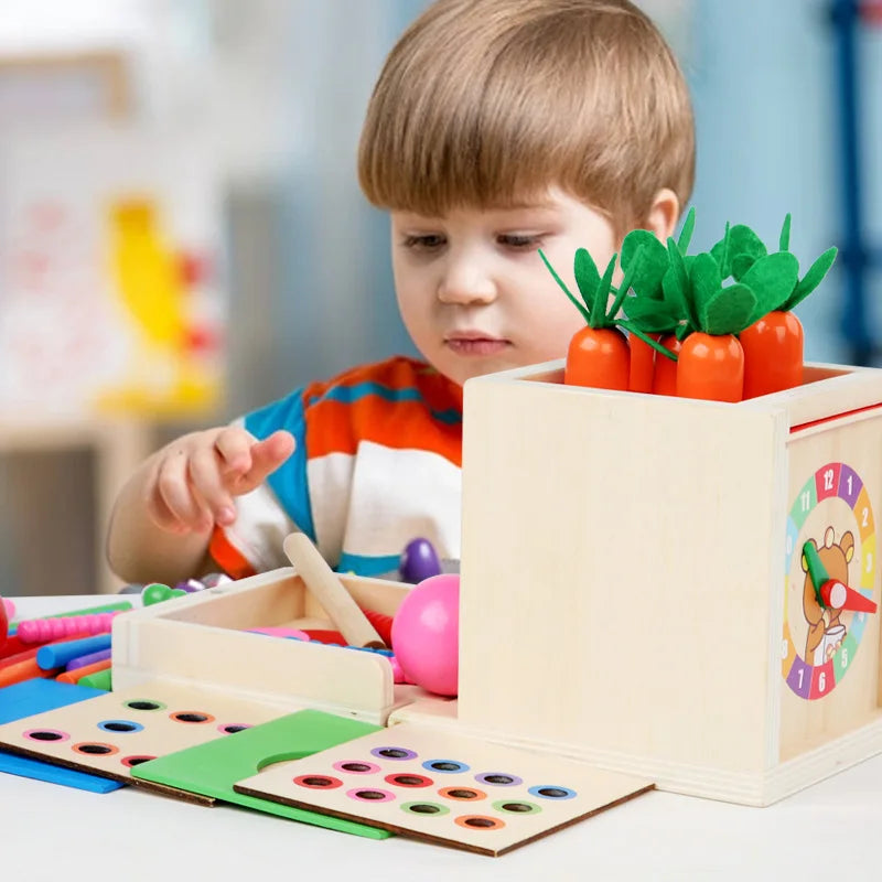 A young boy is playing with a wooden Montessori toy set featuring orange plastic vegetables.