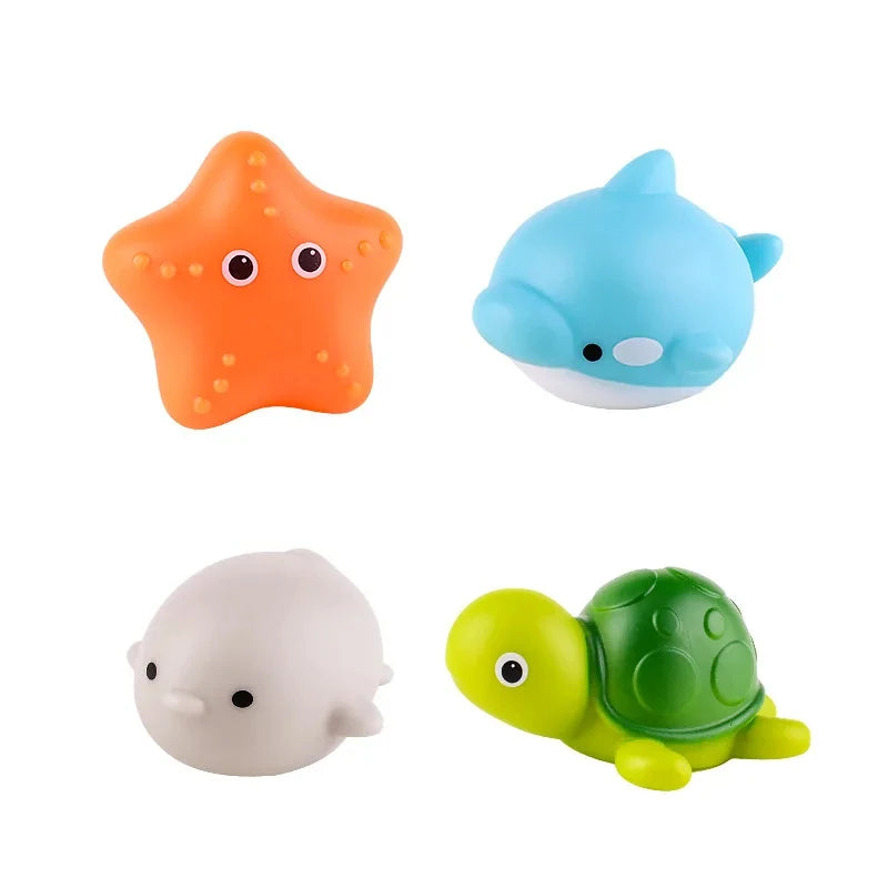 Three glow-in-the-dark animal washing water toys: an orange star, a blue fish, and a green turtle.