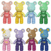 A collection of nine cute bear figures made from micro building blocks in various pastel and earthy colors.