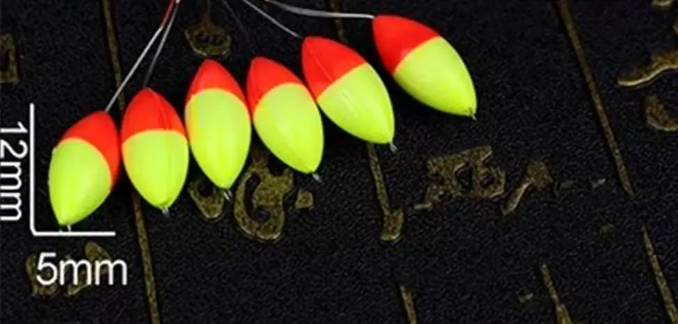 A row of bright red and yellow oval fishing floats with bobber beads are shown against a dark background with scale markings.