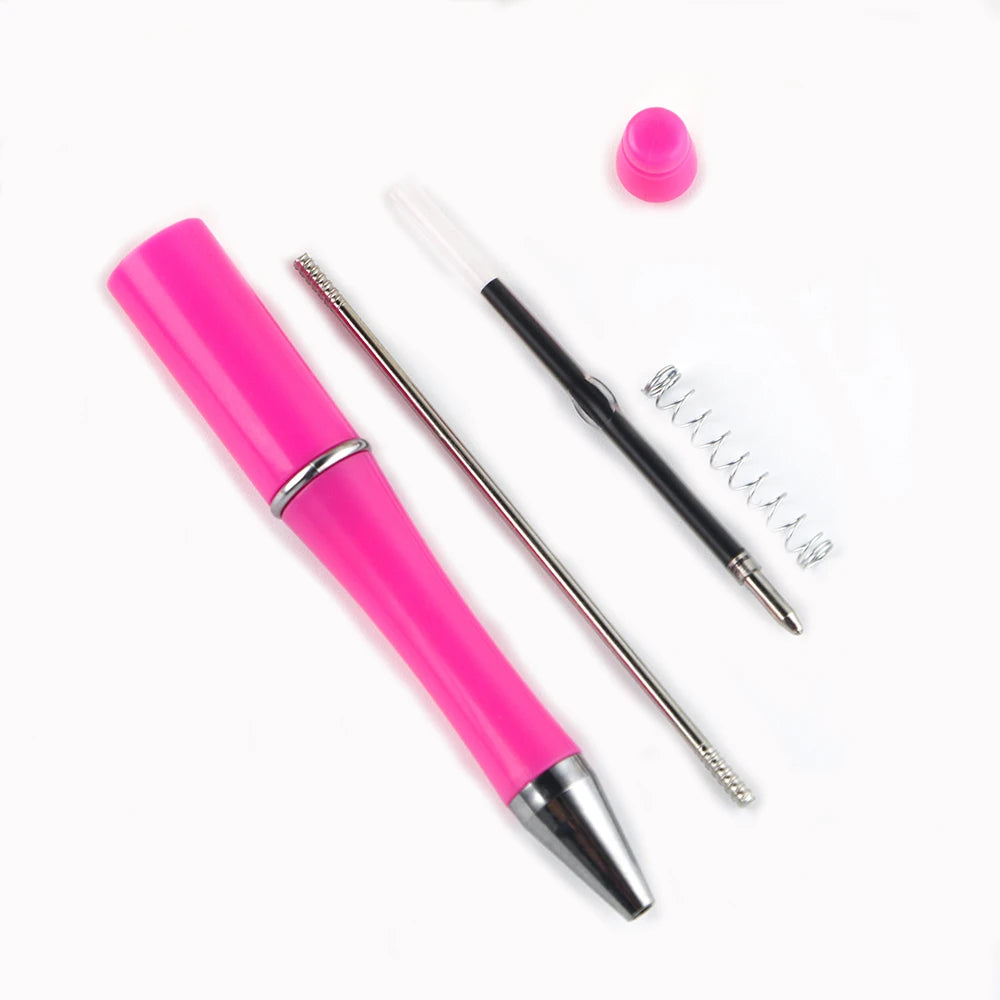 A pink DIY beaded ballpoint pen kit showing a pen and a pink cap on a white background.