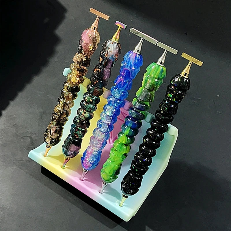 A set of colorful diamond painting pens with stainless steel tips arranged in a plastic tray.