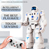 A white robot toy standing next to a remote control, demonstrating intelligent programming and touch sensing features.