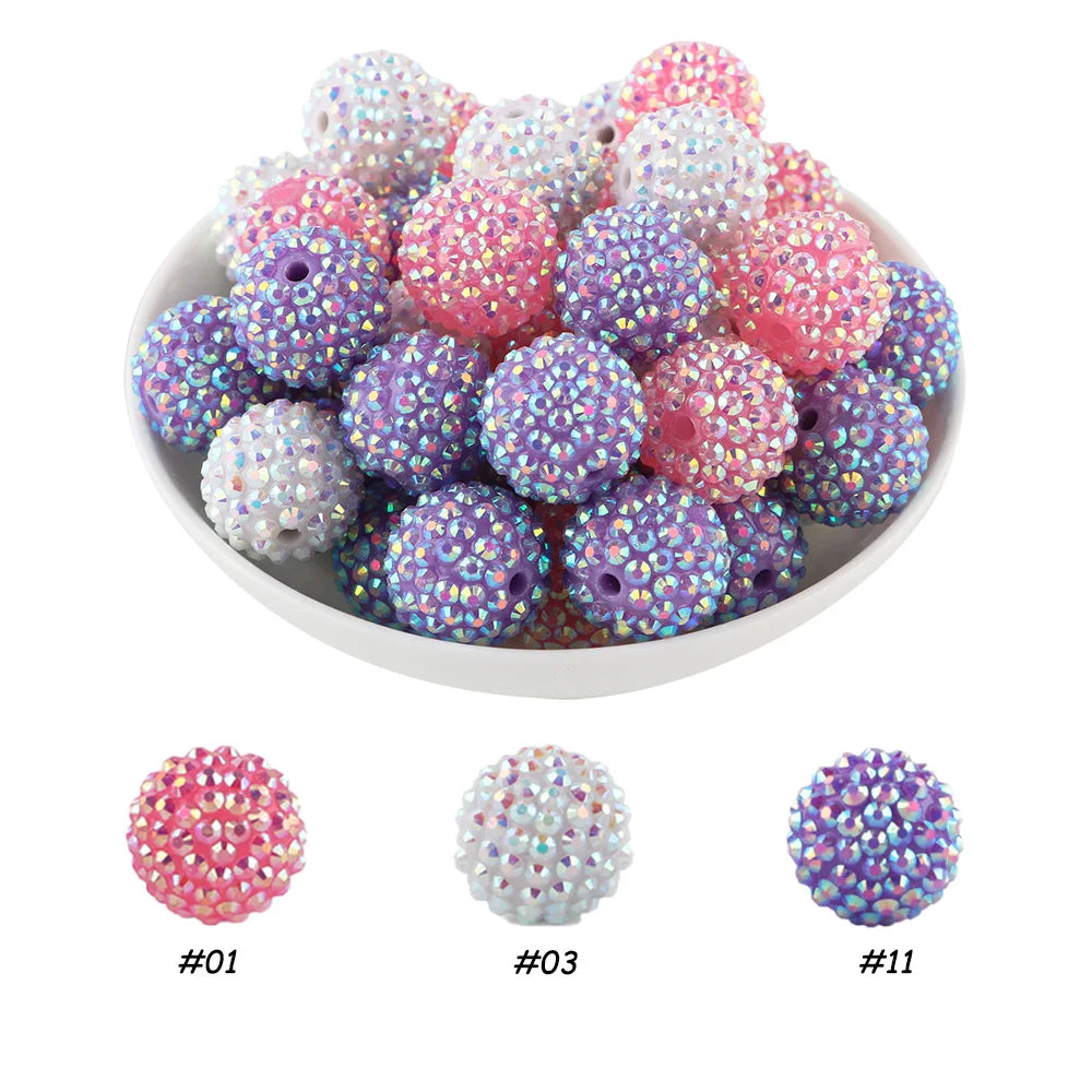 A pile of colorful rhinestone resin bayberry beads in pink, purple, and white for jewelry making