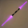 A glowing purple lightsaber toy with a metallic hilt and blade, lying diagonally on a light surface.