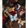 A close-up arrangement of dried flowers and colorful butterflies on a wooden surface.