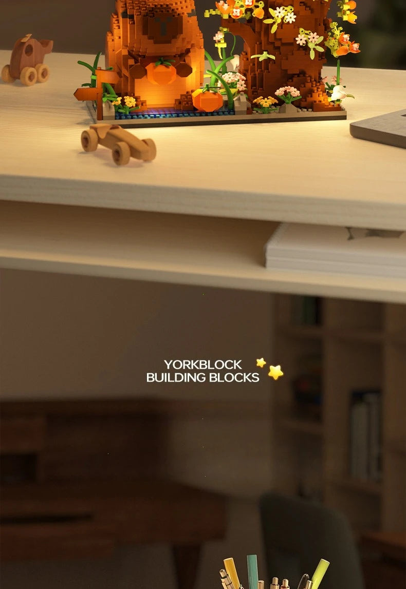 A set of yellow and orange Yorkblock building blocks arranged as a desk organizer featuring a capybara and flowers.