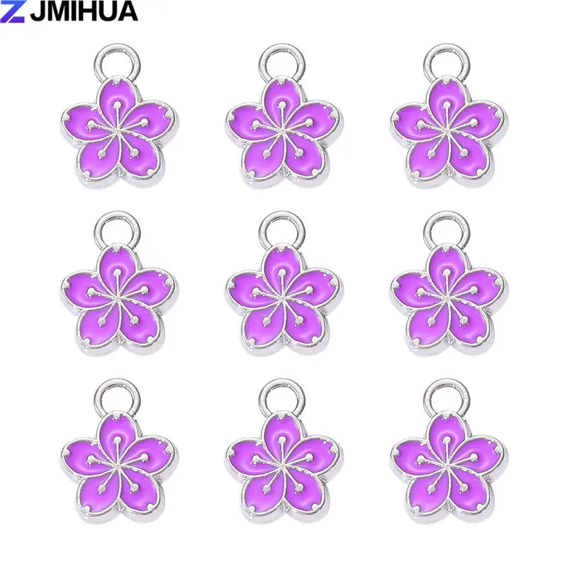 A set of 15 enamel flower and cherry charms for jewelry making in various shades of purple and pink.