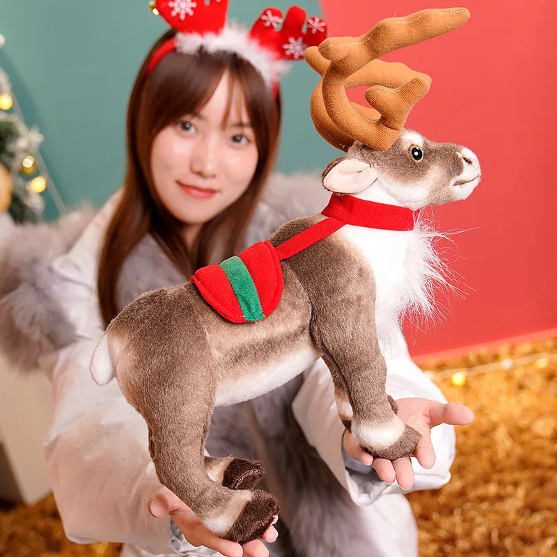 A woman holds a soft plush reindeer stuffed animal with brown antlers and white fur against a red background.