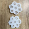 A set of silicone molds shaped like flowers used for baking, soap making, and candle making.