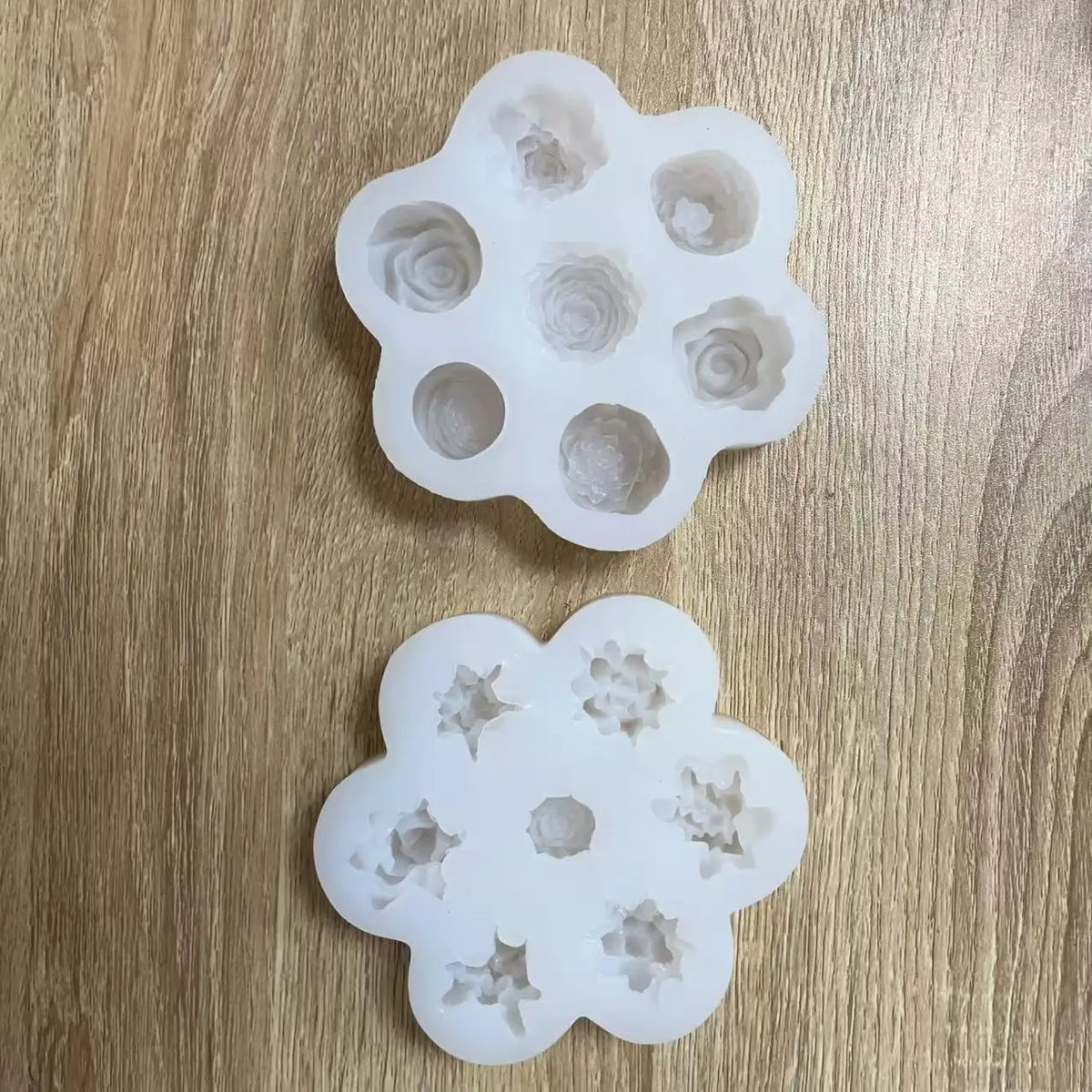 A set of silicone molds shaped like flowers used for baking, soap making, and candle making.