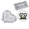 A silicone mold for casting a heart-shaped photo frame, shown in light gray and white.