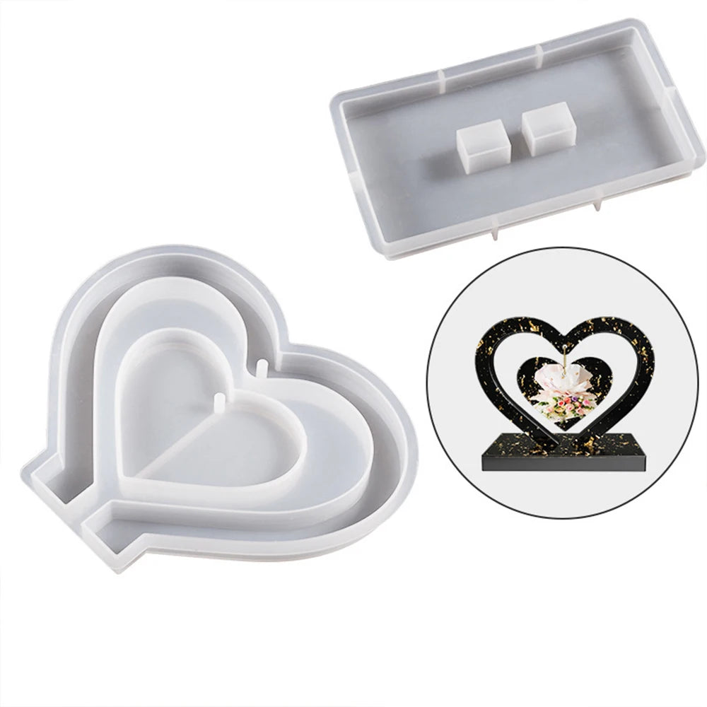 A silicone mold for casting a heart-shaped photo frame, shown in light gray and white.