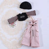 A set of pink and black striped clothing accessories for a doll including a black hat and a pink dress