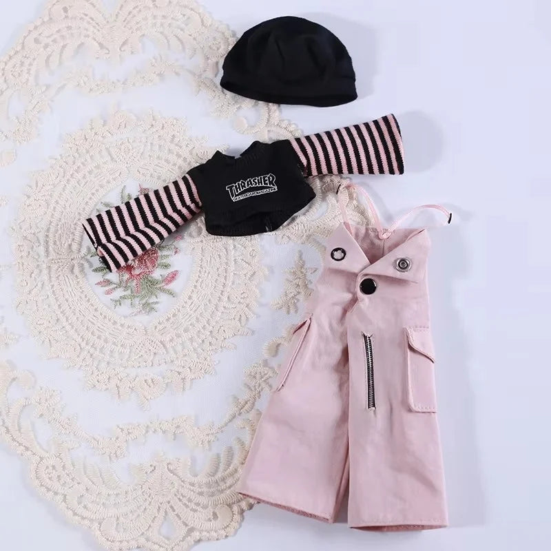 A set of pink and black striped clothing accessories for a doll including a black hat and a pink dress