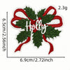 A green felt iron-on patch featuring the word Holly in white embroidery surrounded by red ribbon and holly leaves.