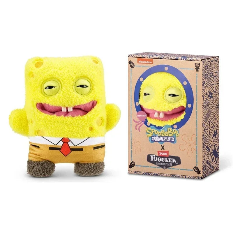 A yellow Fuggler plush monster with a funny grin is shown next to its packaging box.