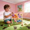 A young boy is playing with a wooden animal puzzle set on a green rug.