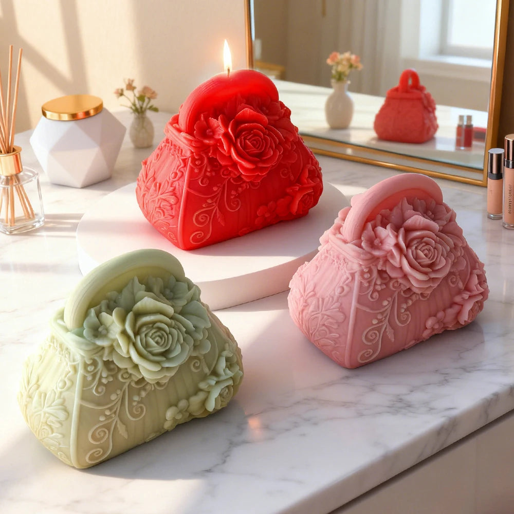 A collection of silicone molds shaped like roses and flowers for candle and soap making displayed on a marble surface.
