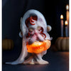 A translucent, pale pink plush doll with reddish hair and glowing orange accents sits on a dark surface.