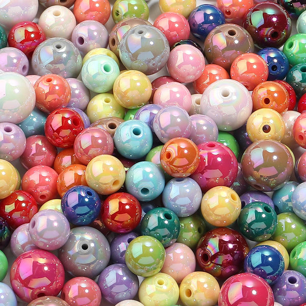 A close-up of various round acrylic spacer beads in a wide array of bright and pastel colors.