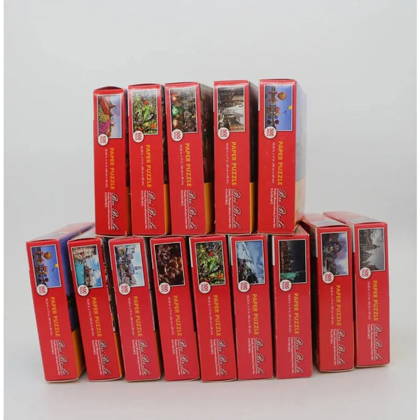 A collection of 10 boxes of a 500 piece landscape jigsaw puzzle in red and brown packaging.