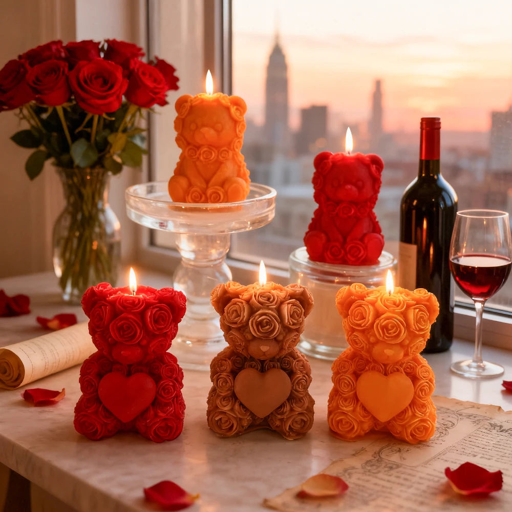 A collection of rose bear silicone candles in red, orange, and yellow are displayed on a table near a window.