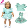 A doll wearing a mint green ruffled top and matching skirt outfit.
