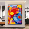 A vibrant abstract painting featuring bold strokes of red, yellow, blue, and purple on canvas.