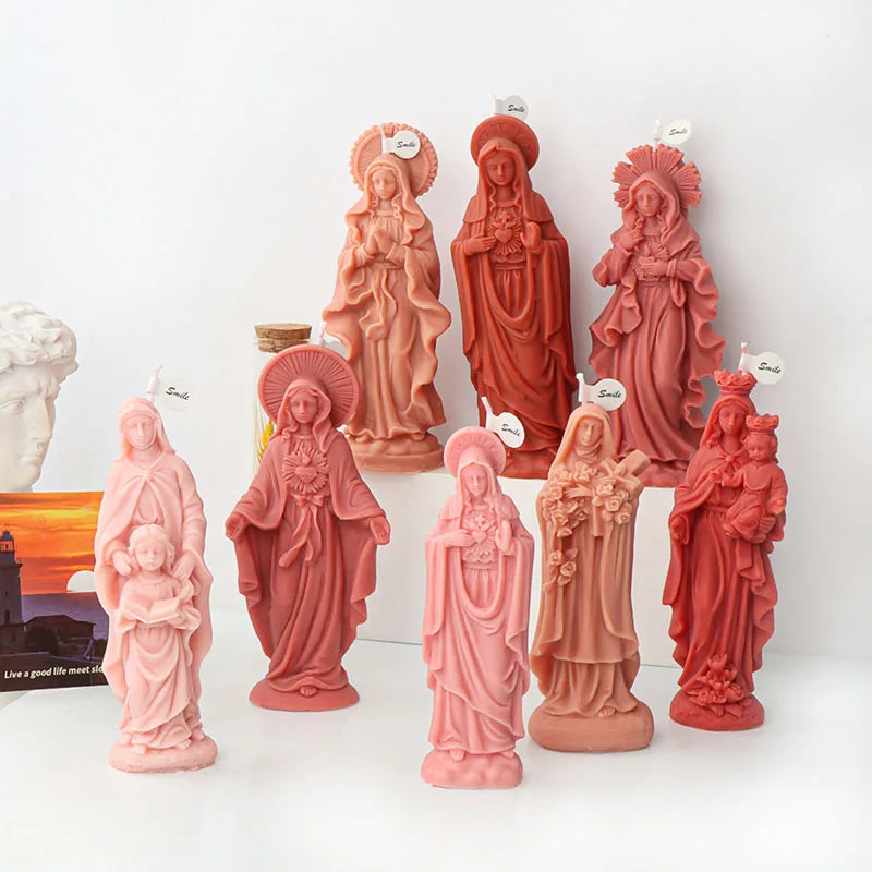 A collection of pink silicone figure molds depicting various religious figures for crafting.