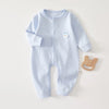 Light blue ribbed cotton baby romper for newborns featuring a small white bear applique