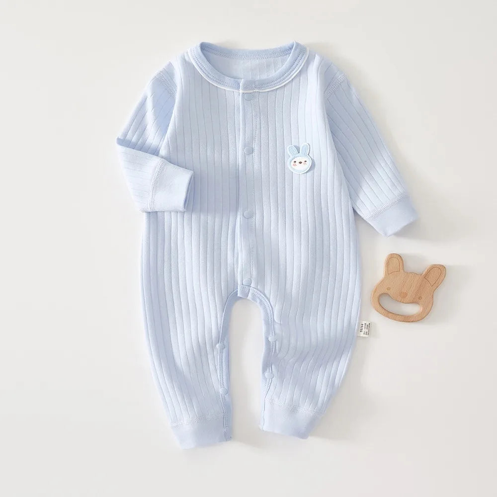 Light blue ribbed cotton baby romper for newborns featuring a small white bear applique