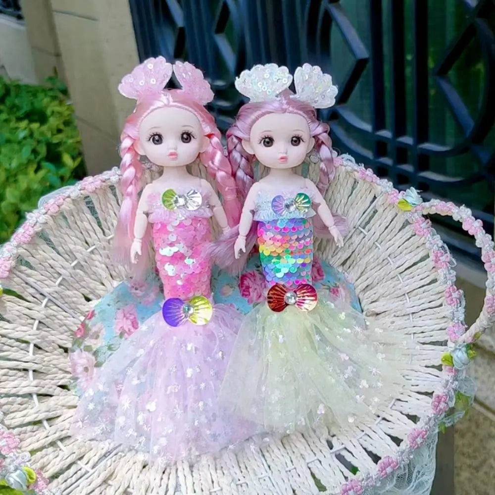 A pink mermaid doll with sparkly hair and a colorful dress is displayed in a woven basket.