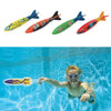 A set of colorful diving torpedo pool toys with numbers and designs floating in clear blue water.