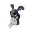 A gray plush doll resembling a rabbit with large ears and a dark body.
