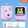 Front and back views of a pink instant print camera showing accessories like a lanyard, paper, and USB cable.