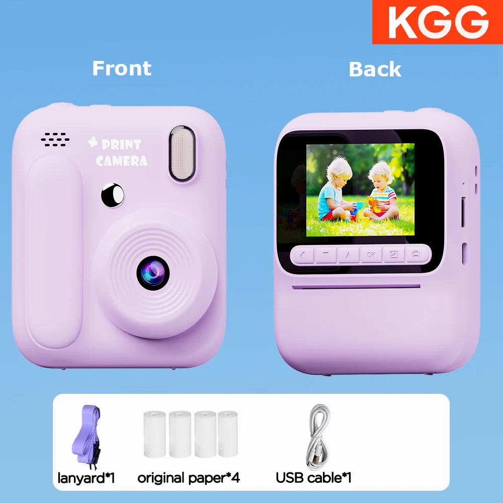 Front and back views of a pink instant print camera showing accessories like a lanyard, paper, and USB cable.
