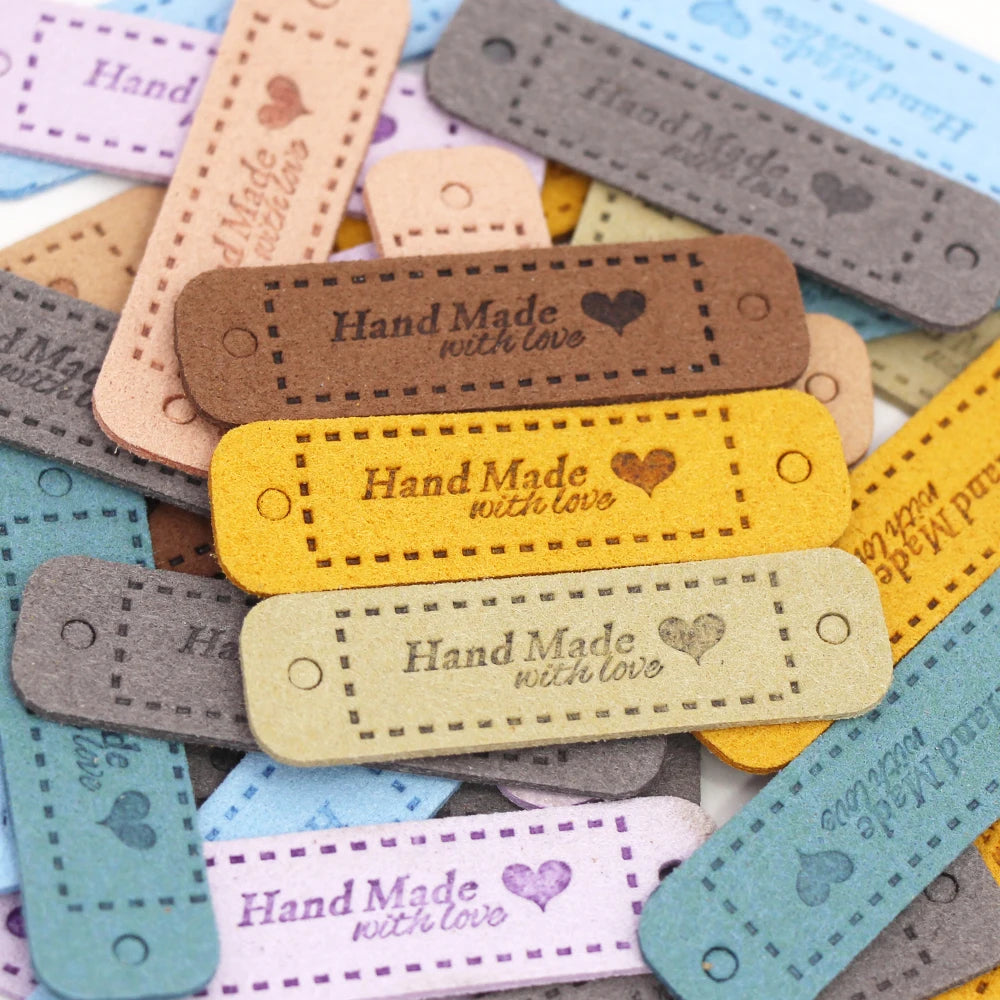 A collection of 20 leather-style handmade with love tags in various colors and textures for crafts